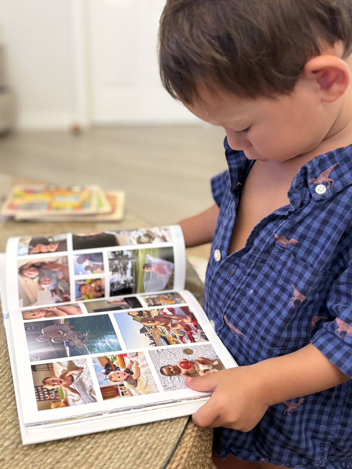 Toddler reading a family photo book